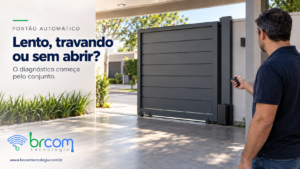 Morador observa um portão automático parcialmente aberto enquanto segura o controle remoto.